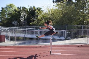 Frangoul practices hurdles and shot put during seventh period.