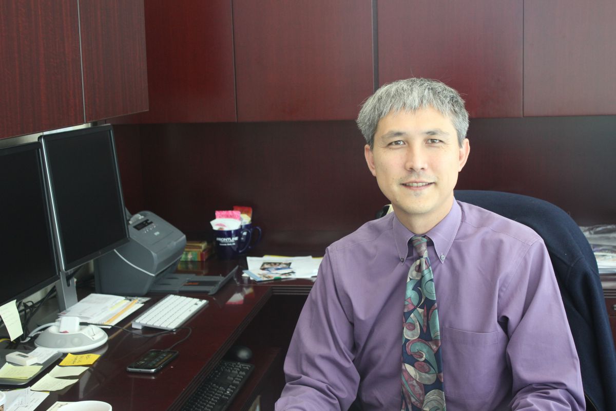 DR. DAVID YOSHIHARA sits in his office located in the district offices on campus.  He is working to aid communication and offer equal opportunity to all students.