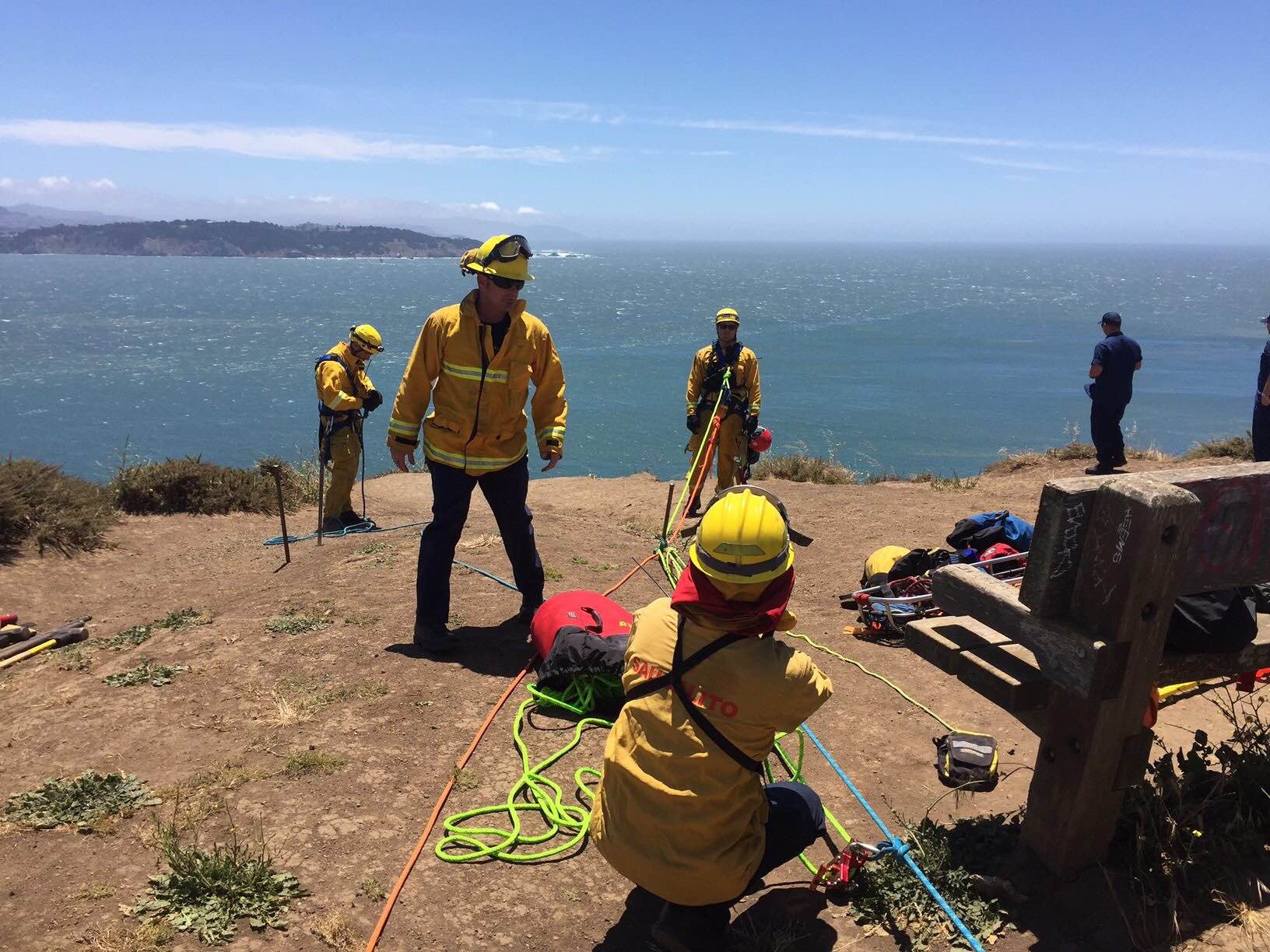 Firefighters help rescue man from cliff.