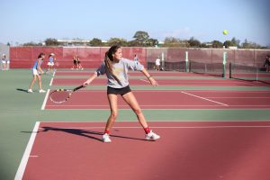 Preparing to hit a forehand, senior Lindsay Thornton watches the ball.