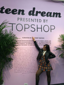 JUNIOR DANA NGUYEN poses in font of the sign for Teen Dream, an art exhibition in New York City. 