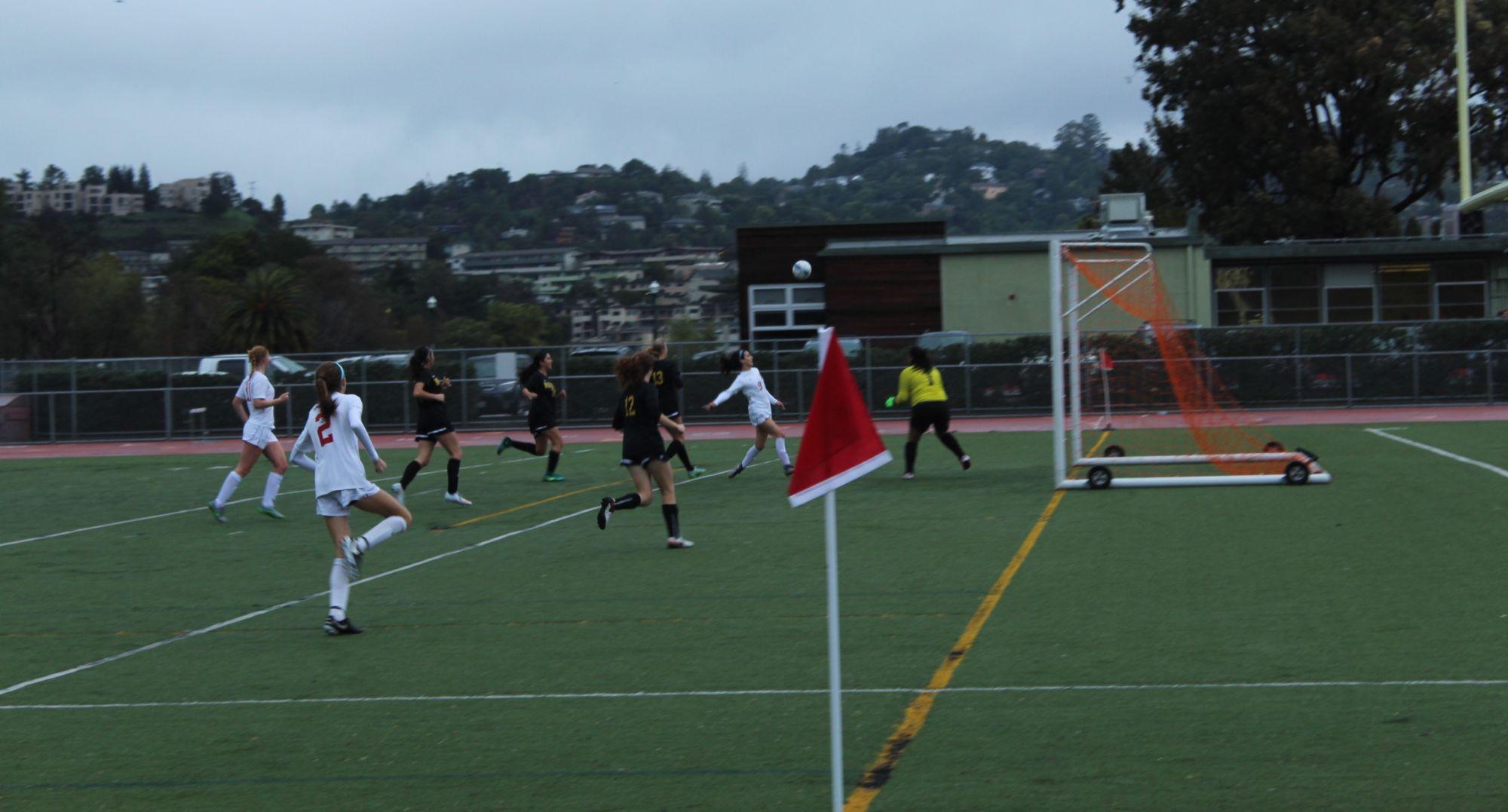 Sprinting down the field, junior Hannah Halford attempts a shot on goal.