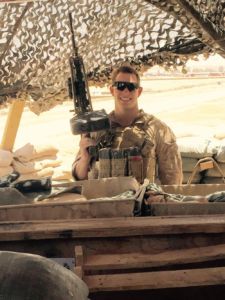 Redwood alum and United States Marine Henry Mesker stands with his weapon while on tour in Iraq.