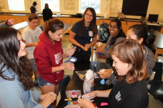 The Bring Change to Mind Club making stress balls during a meeting.