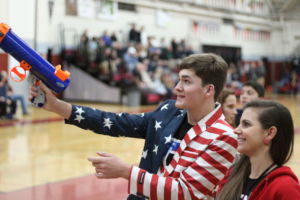 Shooting t shirts into the crowd, junior Greg Datchler spreads the game day spirit.