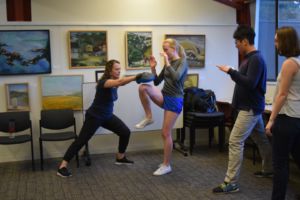 Practicing the knee-to-groin move with instructor Jemma Lester, senior Sarah Noble was part of a small group of teenagers present at the workshop.