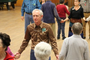 Club President Tom Shores joins in on a group dance 