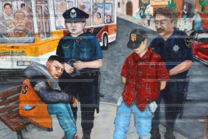 Illuminating the injustice of stereotypes, this mural portrays the pain of two innocent teenagers who are wrongly convicted of a crime as a result of racial profiling. 