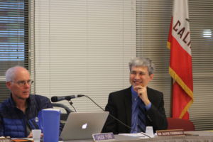 District Superintendent David Yoshihara discusses a resolution with fellow board members at a February board meeting.