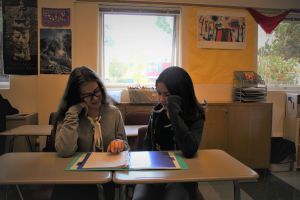 Poring over notes in their binder, Madu Ferreira Vidal and Ruth De Britto help each other study. 