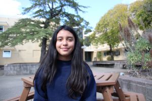 Sitting in the quad, Saidy Reyes takes in another sunny day at Redwood. 