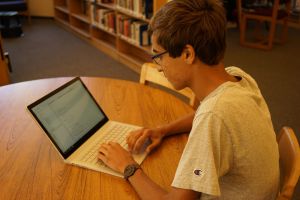 Typing away, senior Austin Patel adds code to his latest artificial intelligence program.