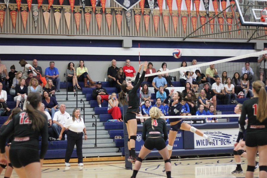 Junior Sophie DiGrazia blocks a Marin Catholic spike. Redwood swept the Wildcats in 3 games. 