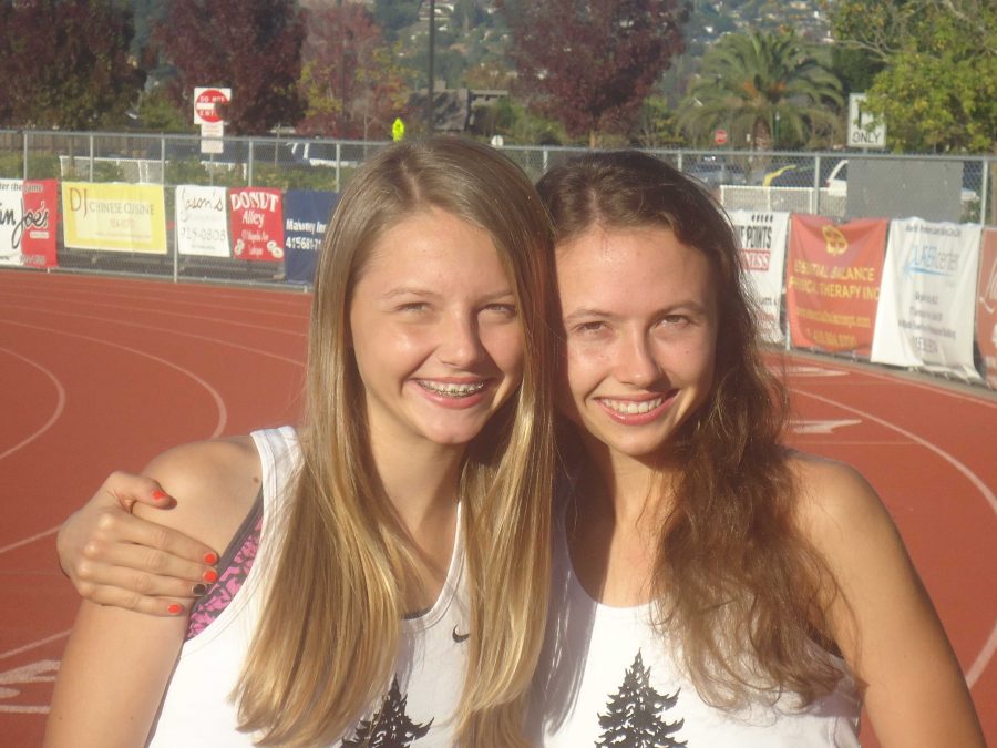 Megan and Rachel pose together on the Redwood track before a recent practice.