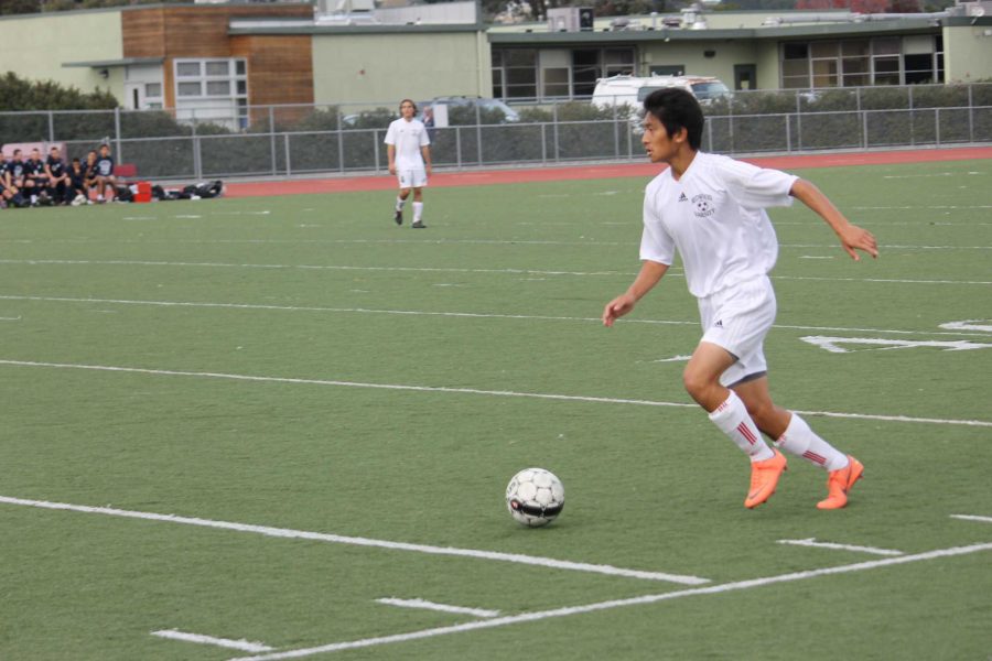 Junior Lucas Wong advances the ball in an NCS match against Marin Catholic. Wong was suspended earlier in the season after a violent collision with an MC player.