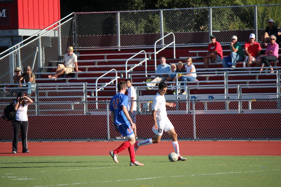 SASHA BOUSSINA, junior, attempts to get around a defender during the varsity soccer team’s match against Tam. Boussina scored 18 goals and had five assists this season. 