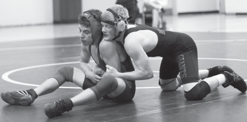 JUNIOR JACK TWOMEY, right, hits the mat during the annual King of the Mountain match against Tam. His win helped Giants wrestlers secure the King of the Mountain plaque for the sixth year in a row.