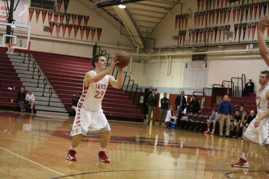 LOGAN MCGUIGAN SHOOTS a three point shot during a game two weeks ago against Branson. 