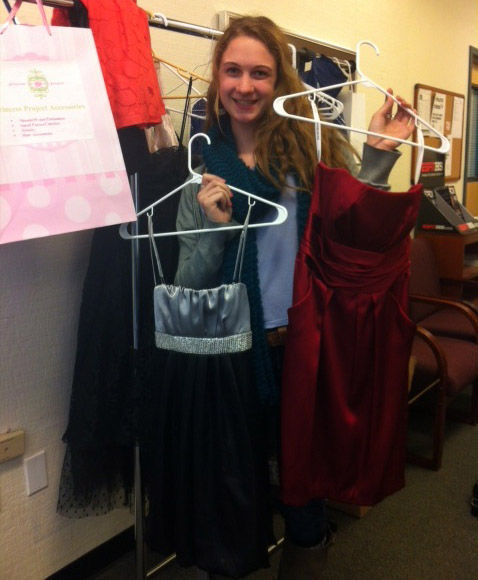 MIRANDA SMITH, junior, poses with just a few of the many dresses she collected to donate to the San Francisco based Princess Project.