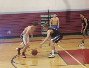SENIOR DAVID MURRAY dribbles the ball past sophomore William Breck during the 3-on-3 basketball tournament that started last Tuesday and wrapped up yesterday.