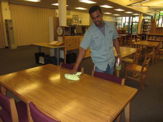 Custodian Amanuel Gebremichael cleans the library after school. He moved to California from Eritrea in 2001 and has lived here ever since.