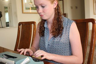JUNIOR MAGGIE DOYLE works on her poetry on her antique typewriter. After submitting her poetry to a contest this year, Doyle was published in a collection of poetry called In My Lifetime. 