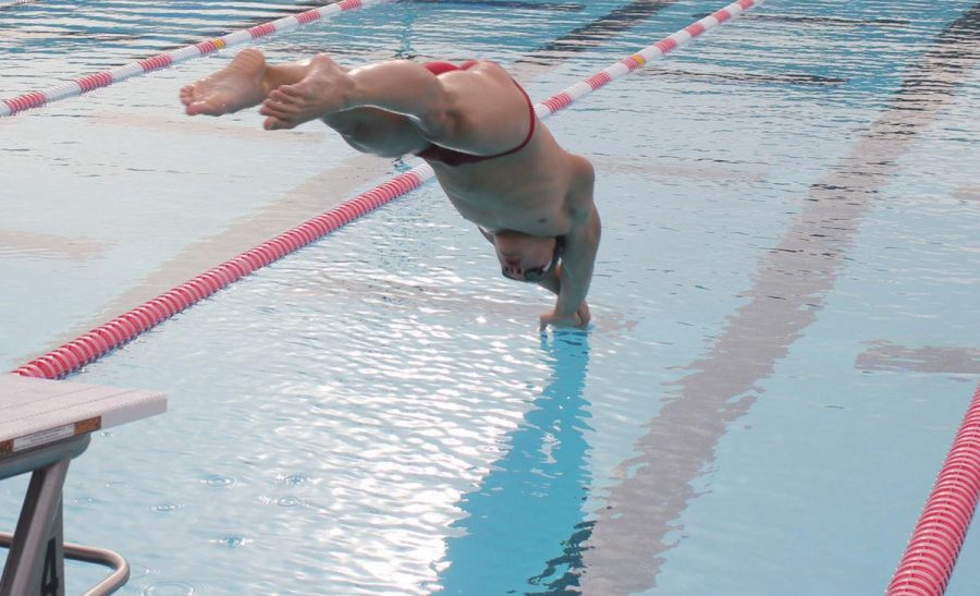 Junior Yaroslav Kurakin dives into the pool at the start of a 100 yard butterfly race at a Redwood home meet March 15. Kurakin has responded to a disappointing near-miss at the cut for Junior Nationals by continuing to practice eight times a week. 