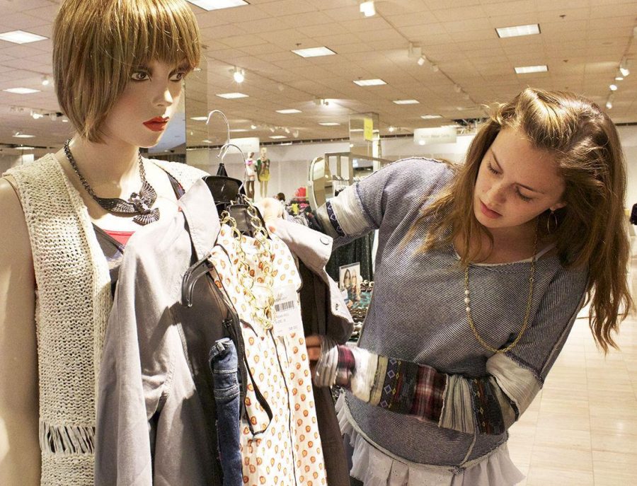 HOLDING  UP HER outfit to a mannequin, junior Taryn McCarthy and BP fashion board member examines her creation at the Corte Madera Nordstrom. 