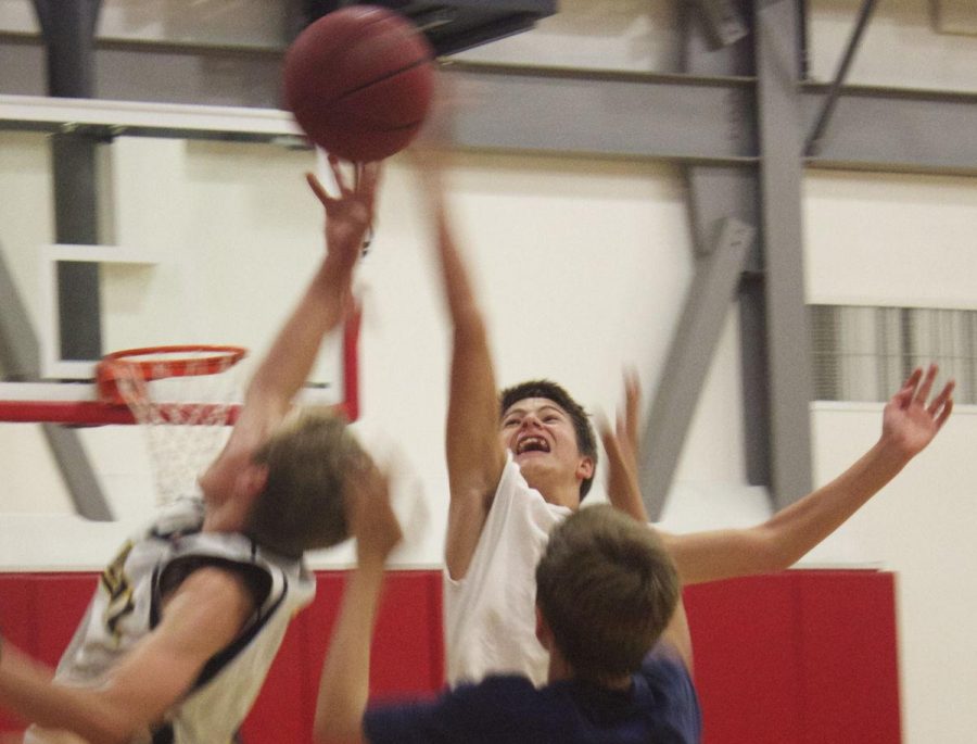 Freshman basketball player, Blaise Van Brunt, reaches for the rebound during open gym 