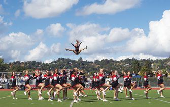 Cheerleaders perform a stunt at the Sept. 21 football game against San Marin