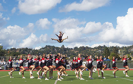 Cheerleaders perform a stunt at the Sept. 21 football game against San Marin