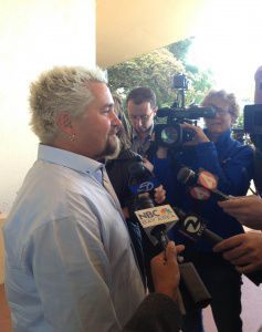 Celebrity chef Guy Fieri is surrounded by reporters after finishing his testimony Monday afternoon.