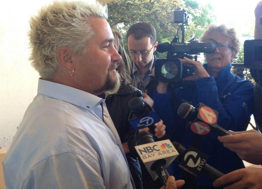Celebrity chef Guy Fieri is surrounded by reporters after finishing his testimony Monday afternoon.