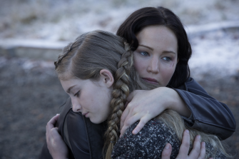 TRAUMATIZED by her experience in last year's Games, Katniss Everdeen (Jennifer Lawrence), hugs her sister Primrose Everdeen (Willow Shields). Lawrence captured Katniss's emotions with just her eyes. 