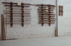Bokken, the long staff on the left, and jo, the short staff on the right, hang inside the dojo of Bay Marin Aikido