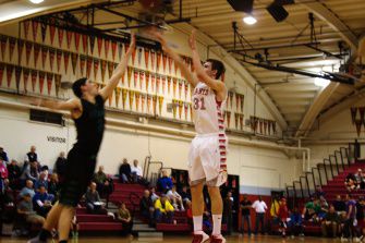 Junior Will Breck fires a three-pointer over Branson's Henry Feinberg. Redwood's excellent three-point shooting faltered against the Bulls, as the Giants shot just 5-of-23 from beyond the arc.