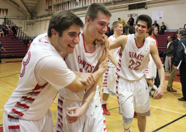 Nick Jones, Will Breck, and Jack Bronson rejoice after Breck's last-second free throw sent the Giants to the MCAL semifinals.