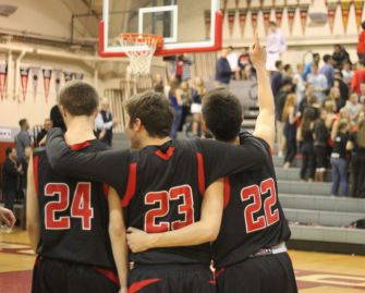 Seniors Peter Kennedy (24), Nick Jones (23), and Jack Bronson (22) prepare for the MCAL semifinal game against Branson, in what would be their last game on their home court.