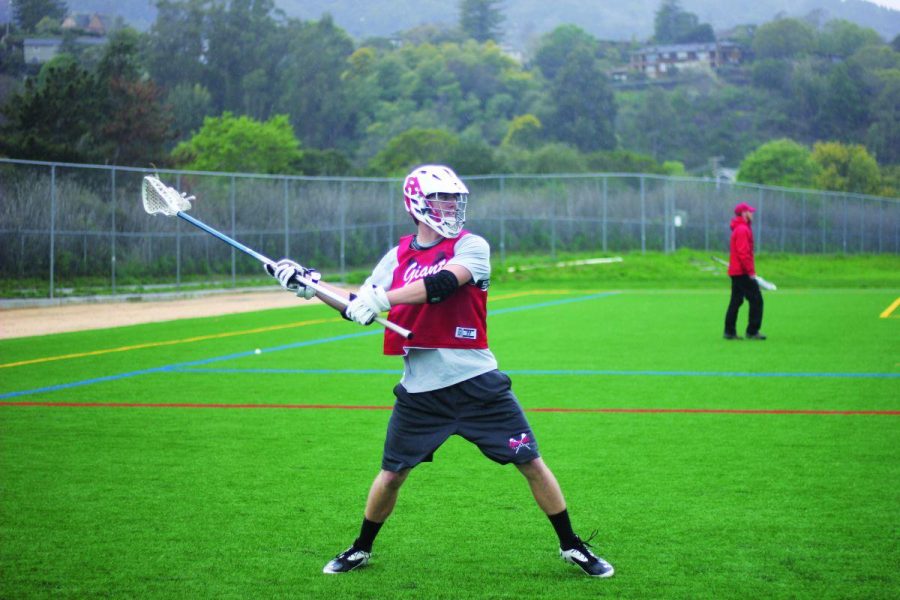 Senior Liam Bourke practices on the new field during a rainy practice