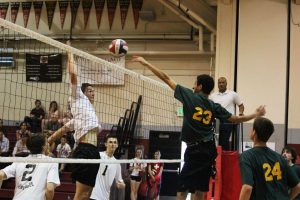 SENIOR LUKE PFEIFFER hits into a block by San Marin at the men's volleyball game last Wednesday.
