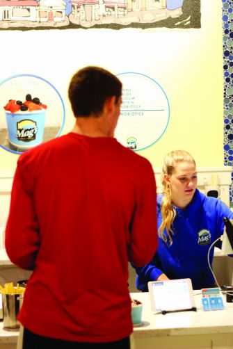 Redwood student Katherine Grellman serves a student at Mag's Local Yogurt in downtown Larkspur