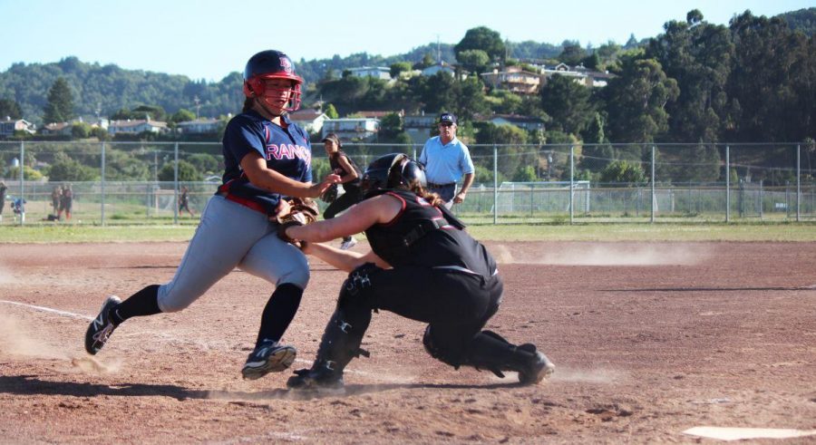 Redwood catcher Shawn McCullough applies a tag and braces for a collision at home plate in the ninth inning.