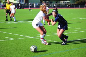 DEFENDER SHAYA BARRY of Redwood faces off against MC forward Alexis Tye at last Wednesday’s MCAL playoff game. The Giants lost 1-0, ending their MCAL season. 