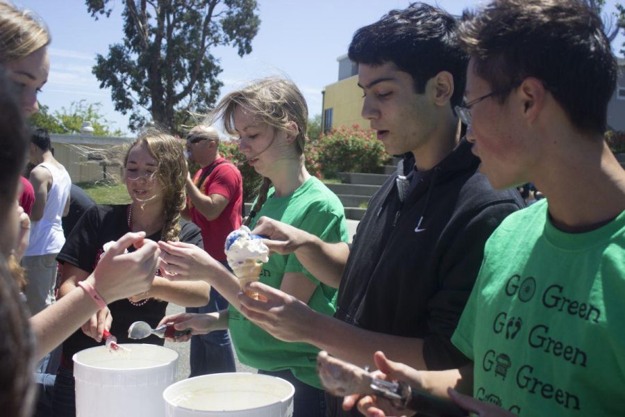 Scooping ice cream for ravenous students, Environmental Action Club members bribes the student body to stay on campus during lunch on May 22.