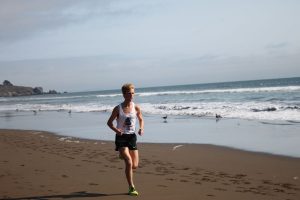 Boys' captain Andy Ehrenberg races along the Stinson shoreline last Tuesday, earning a spot among the top five time scorers of the afternoon. 