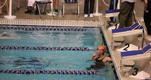 Senior and recently committed Emma McCarthy, catches her breath at the end of a swim race. 