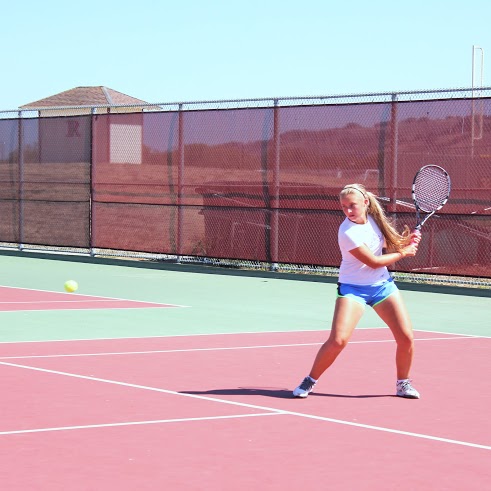 First ranked on the team and junior Lauren Wolfe takes a backhanded swing to the ball.