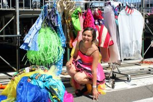 Bella Vega poses next to a clothing rack at designer Traver Rains’ fashion show at San Francisco’s Gay Pride Parade on June 29.
