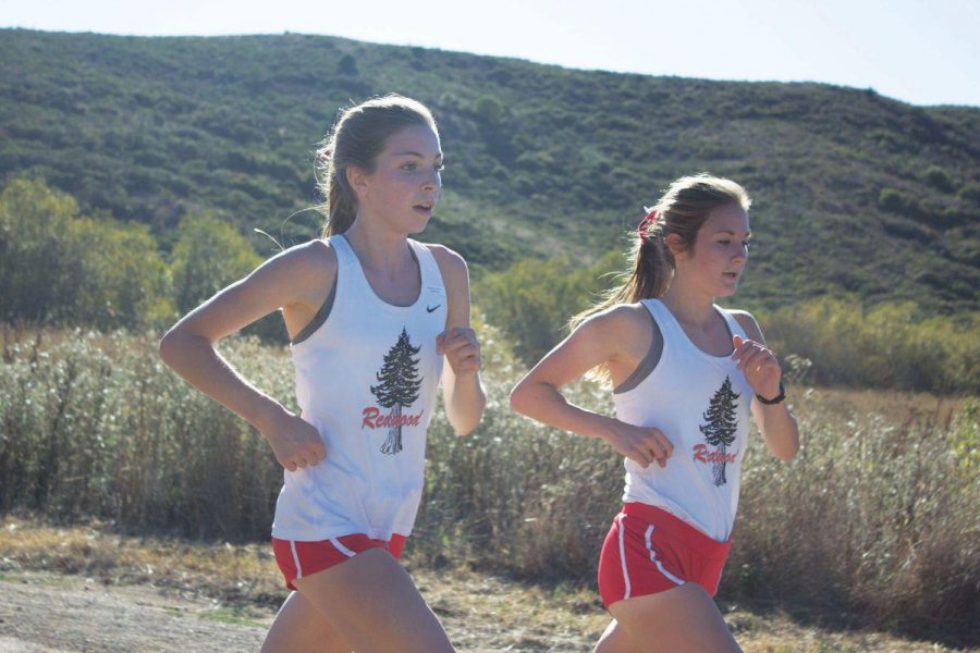 Sophomore Glennis Murphy runs side-by-side with co-captain Mary Monday Oewel in a meet at Tennessee Valley.