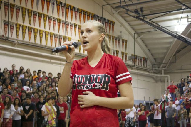 Junior Sophie Keaney sings the national anthem to kick off the Homecoming Rally.